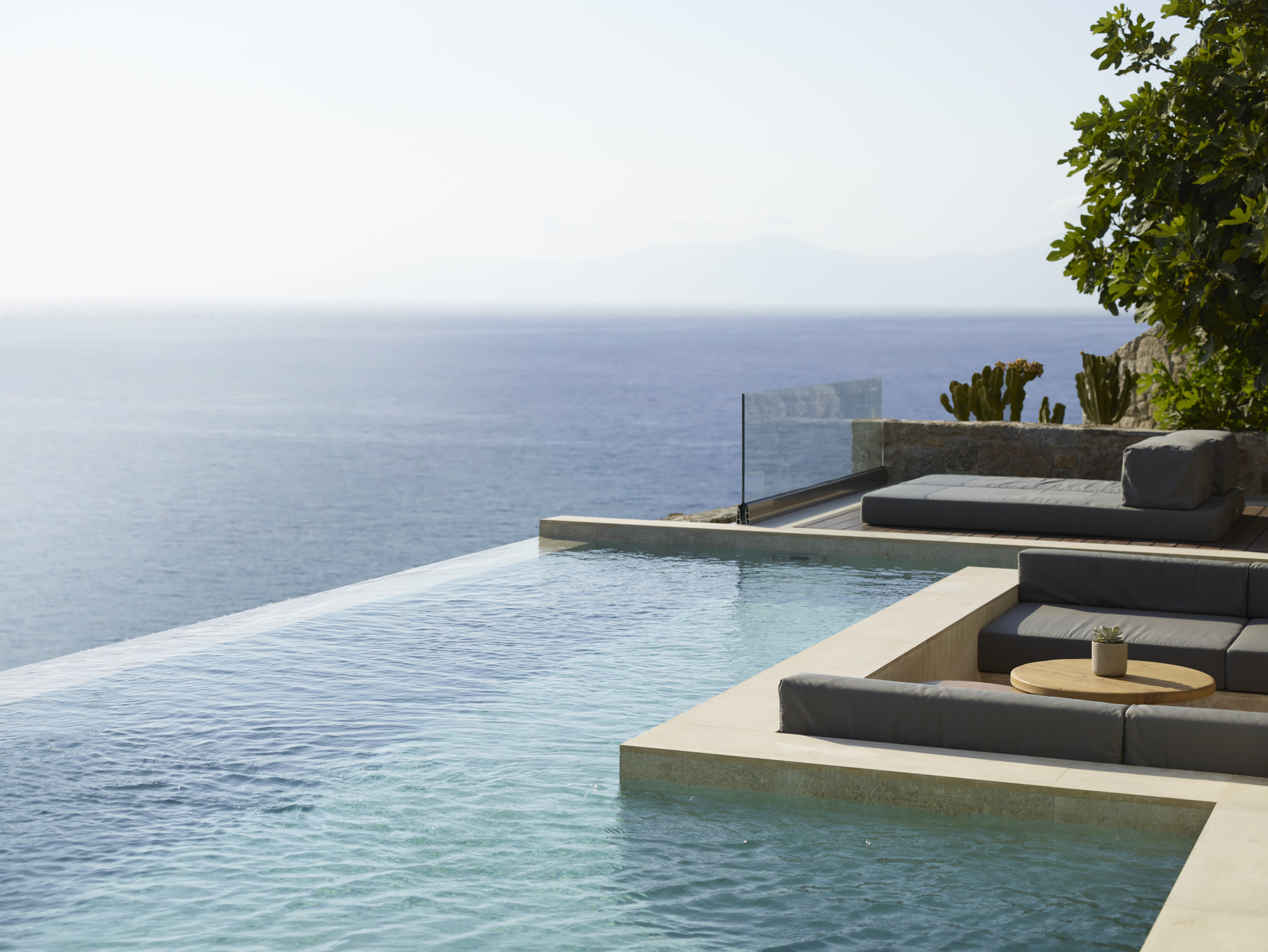a sleek modern terrace with an infinity pool overlooking the ocean