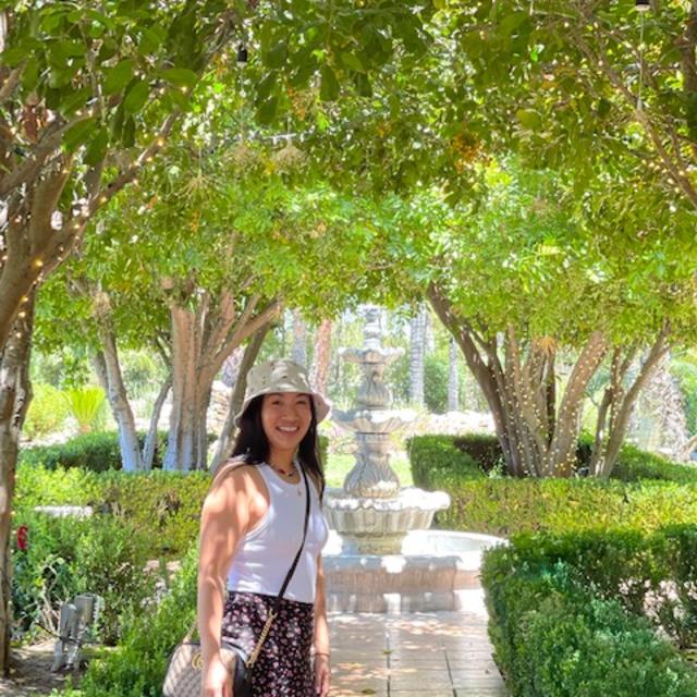 Fora travel agent Kathy Nguyen standing in a park