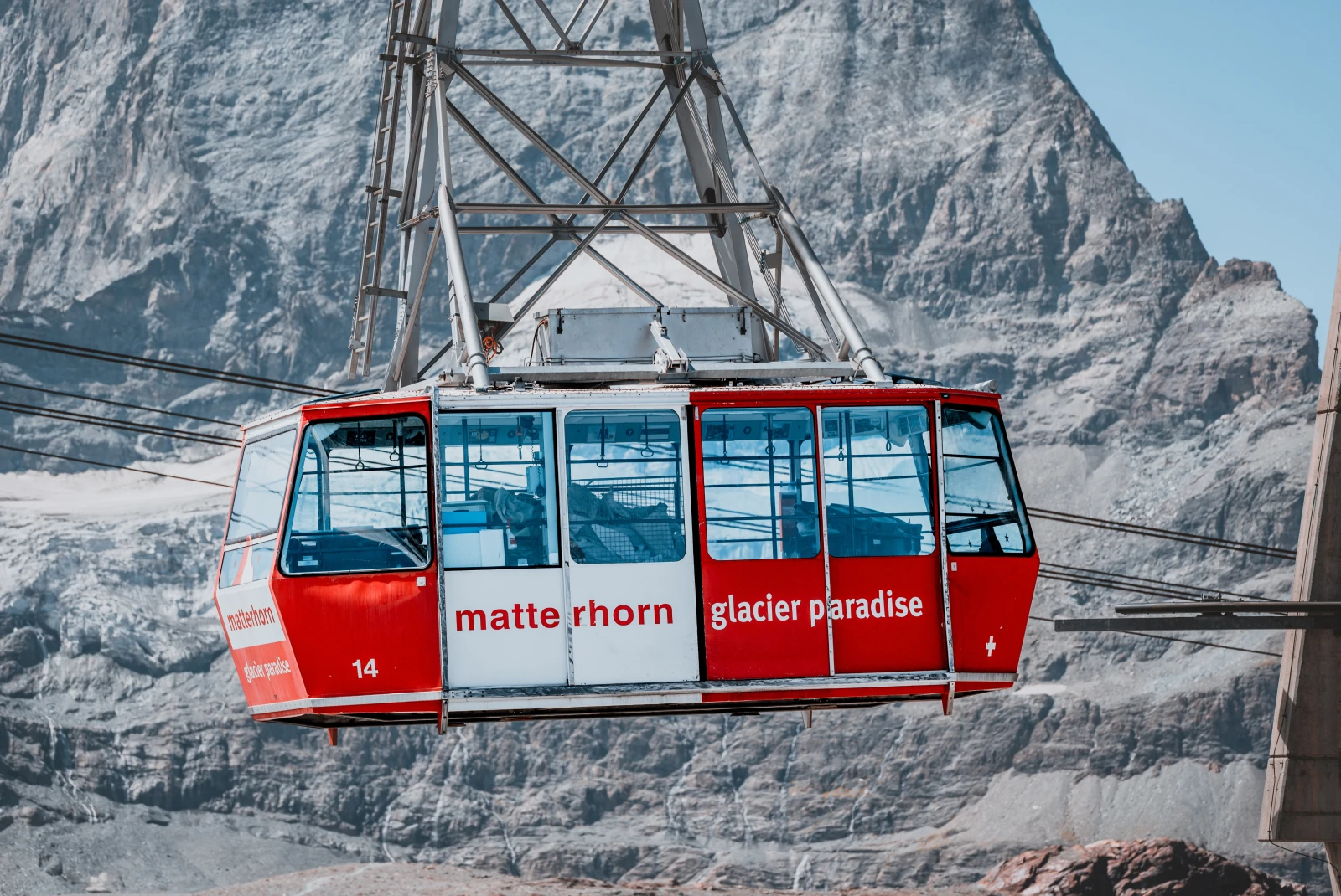 red cable car next to large mountain