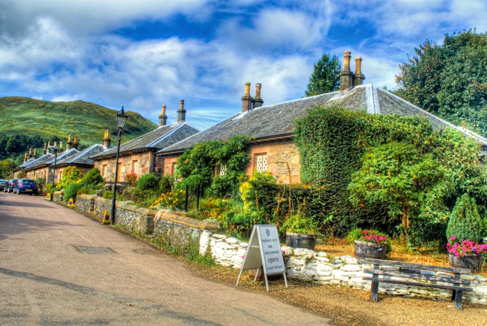 small village street with green mountains in the background