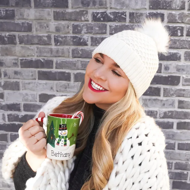 Girl in beanie with mug of hot chocolate
