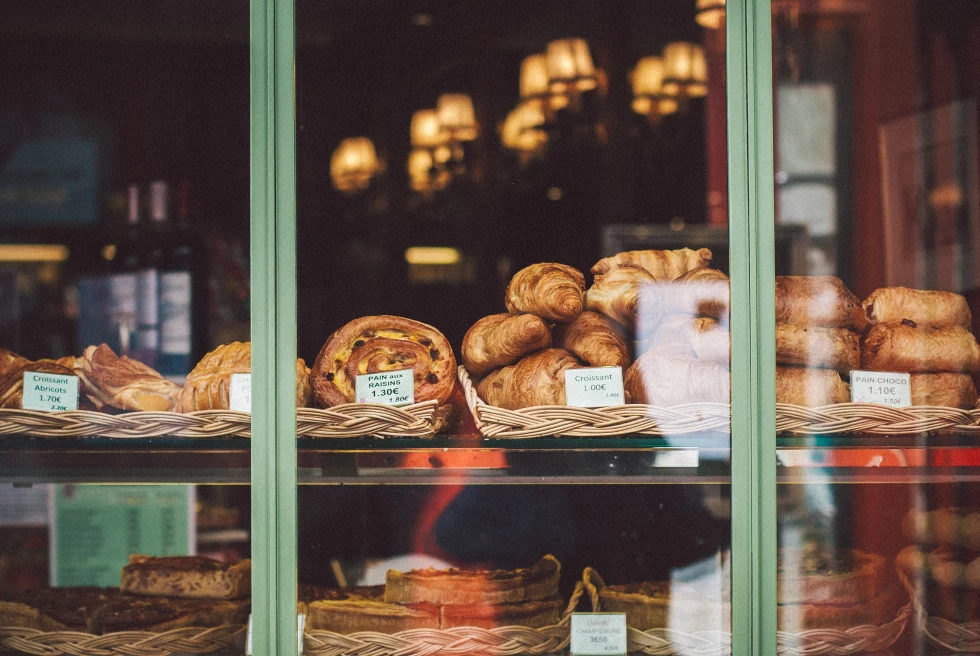 pastries on a shelf through a window