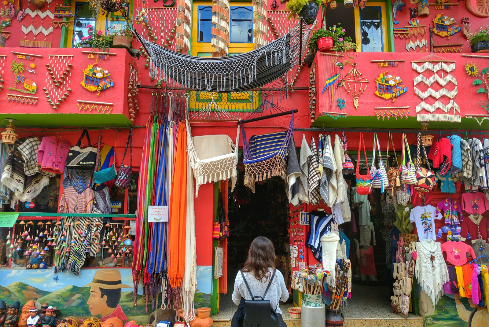 woman standing in front of pink building