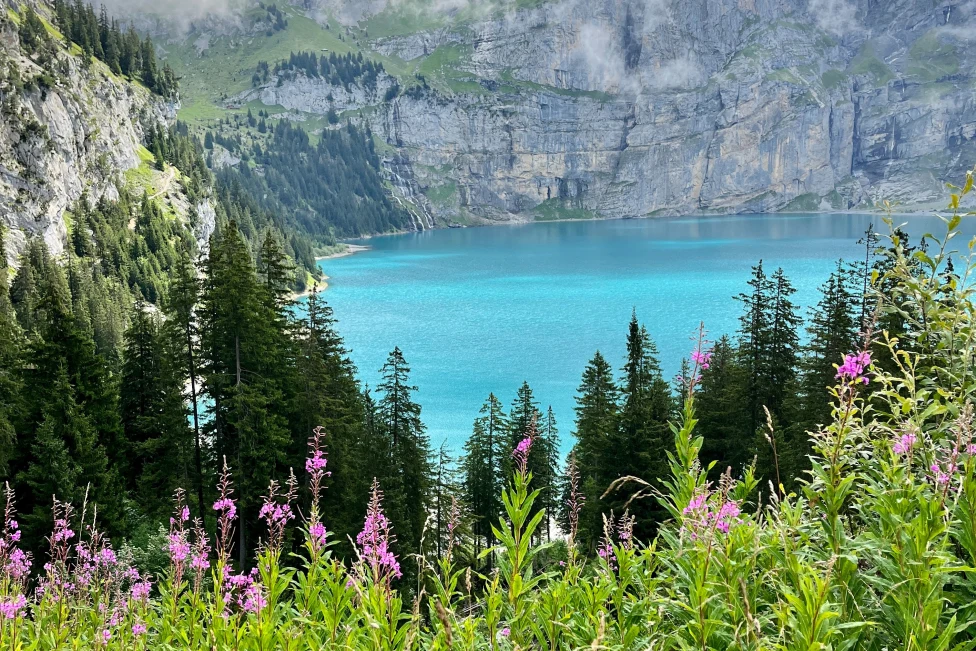 Oeschinen Lake is a stunning alpine lake in Switzerland, renowned for its crystal-clear waters and picturesque mountain surroundings.