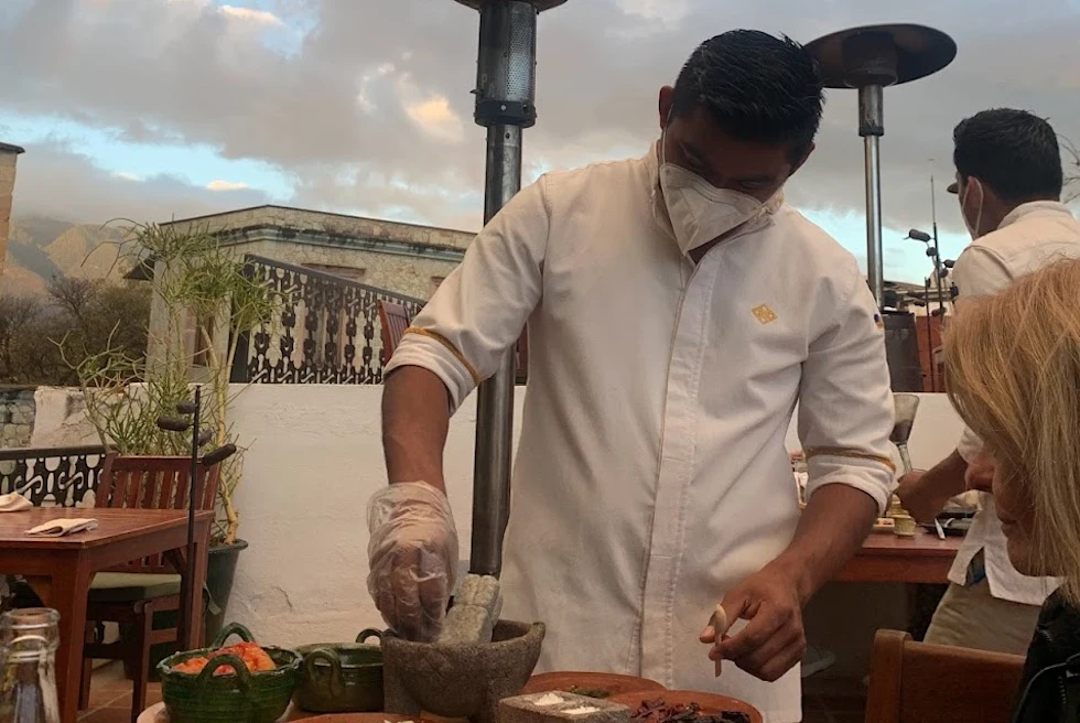 A waiter serving food on rooftop.