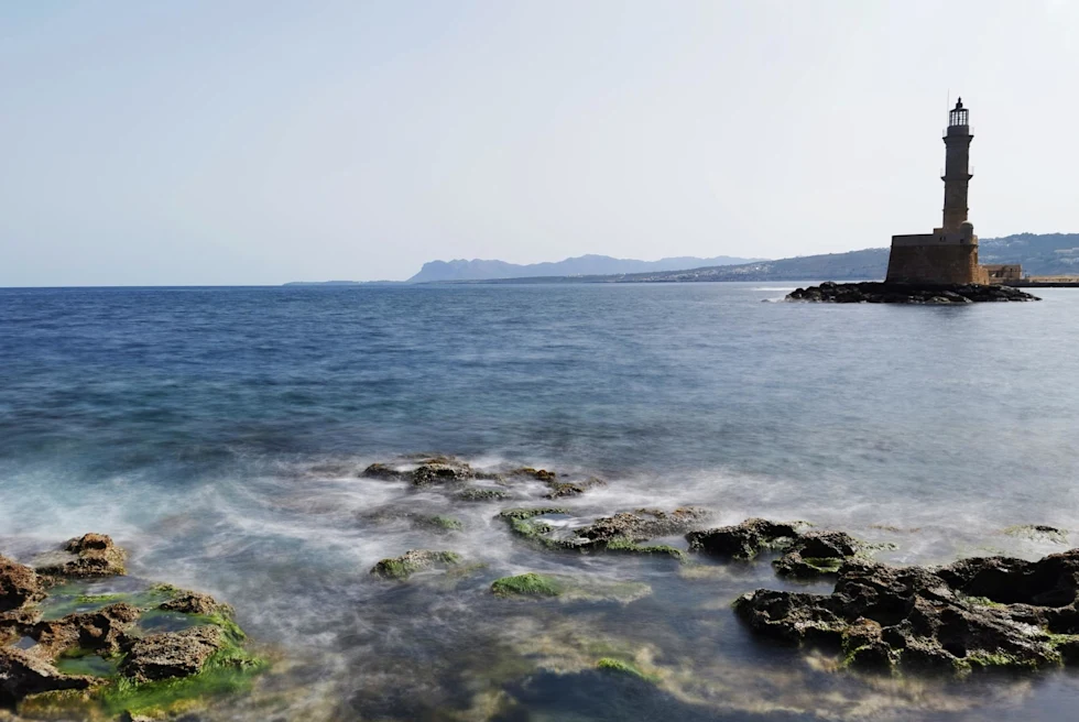 Lighthouse in a sea during daytime