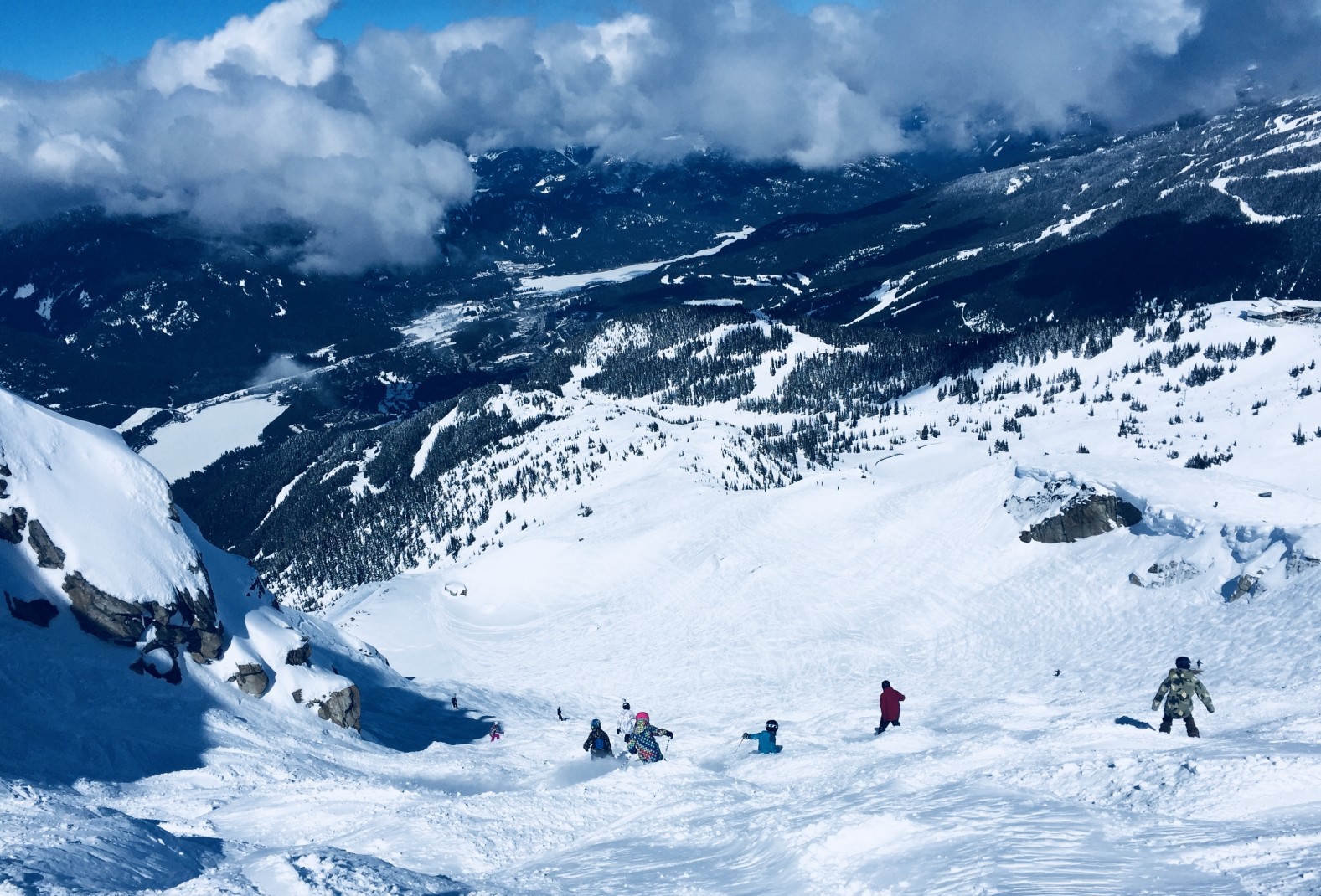 skiers on a snowy mountain during daytime