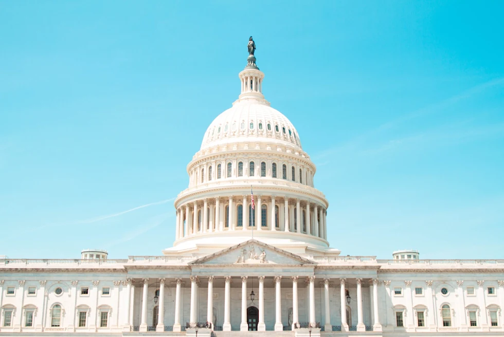Capitol building during day time with blue clear sky.