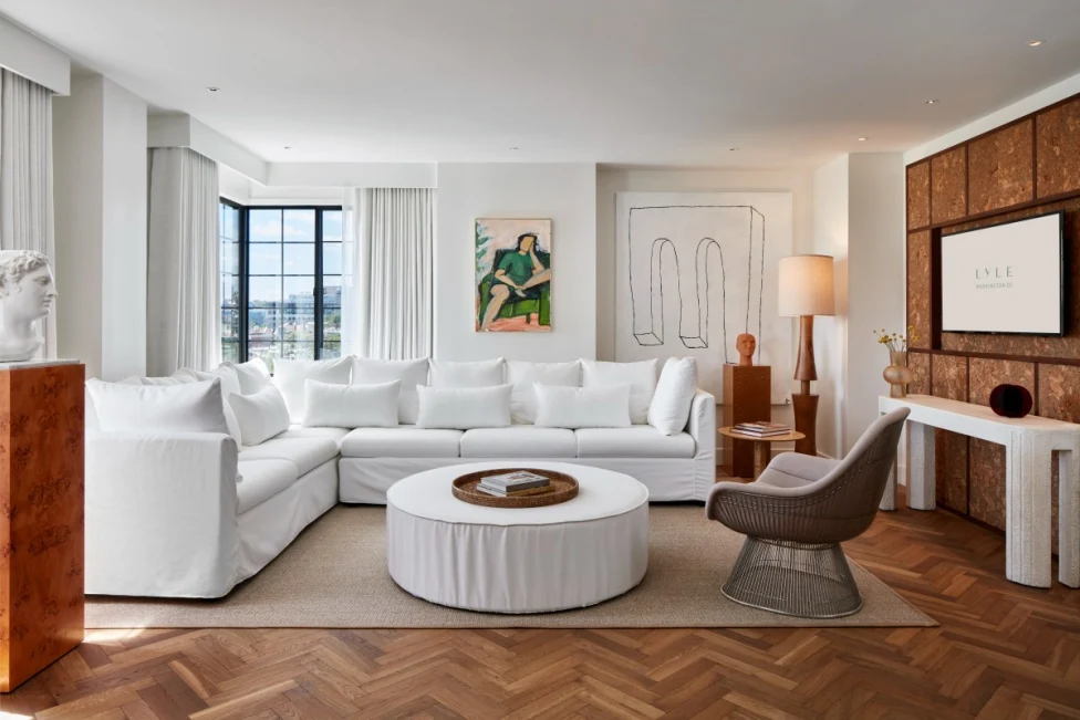 chic living room with a white L-shaped couch and modern art