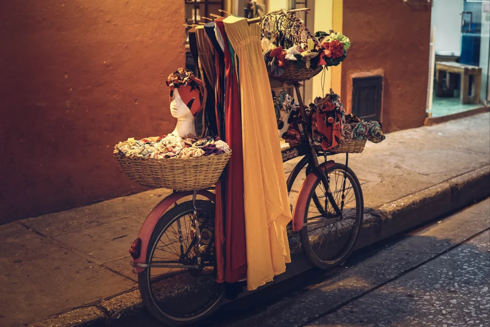A picture of bicycle with dresses and flowers