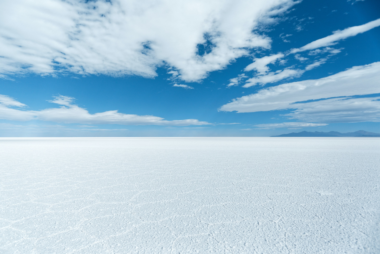 Bright white salt flats with a bright blue sky