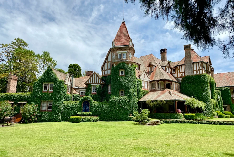 an ivy covered house with a green grass front yard