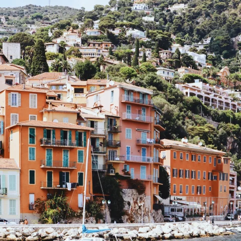 orange buildings on hillside coastal town