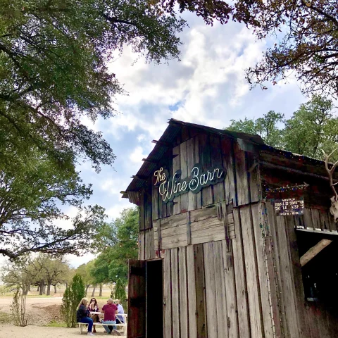 rustic wine barn with a sign that reads "The Wine Barn"