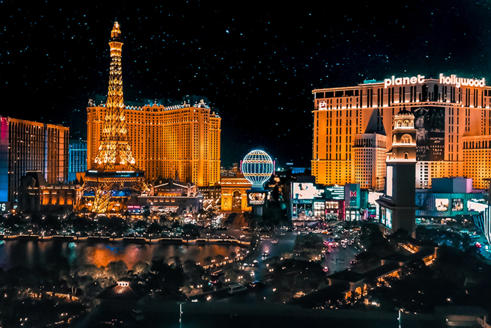 Las Vegas Strip in Nevada at night with orange lights illuminating buildings 