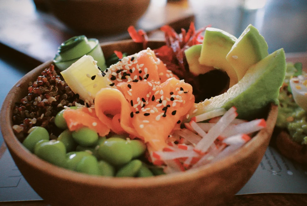 Poke bowl filled with salmon, avocado and other vegetables.  