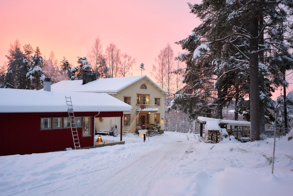 buildings covered in snow during sunset