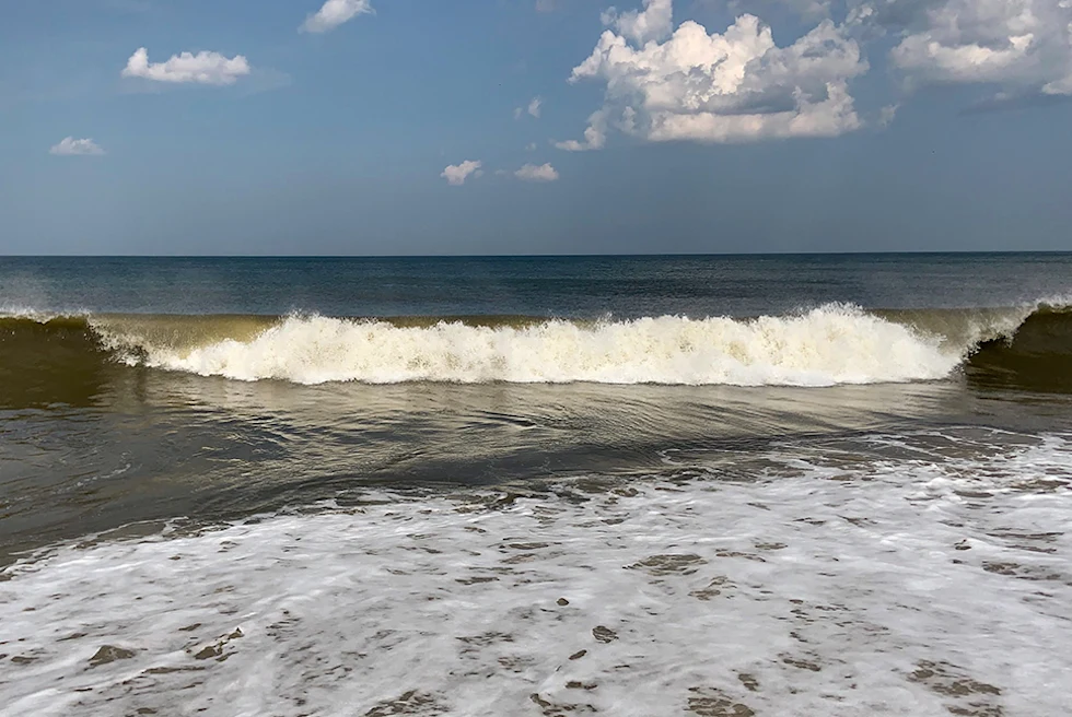 Large waves crashing near the shore at Rehoboth beach.