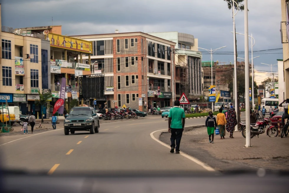 rwanda city streets with people walking and cars driving cloudy sky