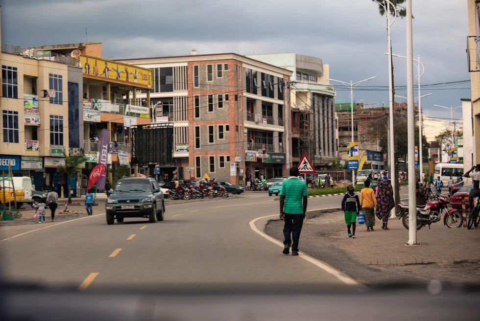 rwanda city streets with people walking and cars driving cloudy sky