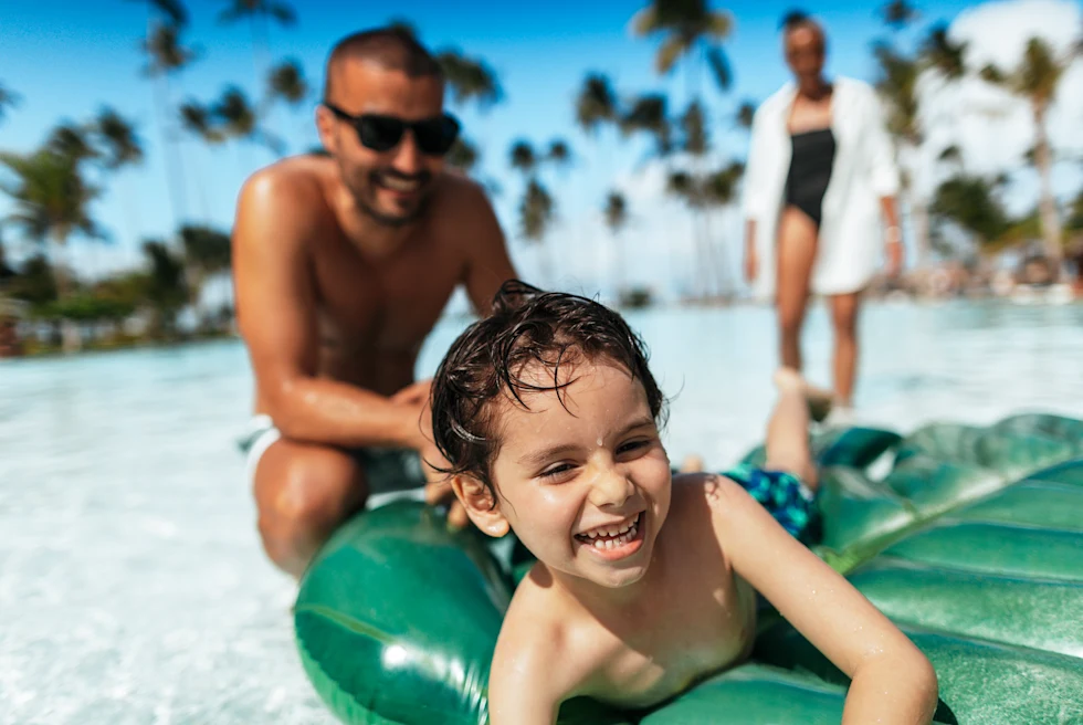 A family playing in a pool.
