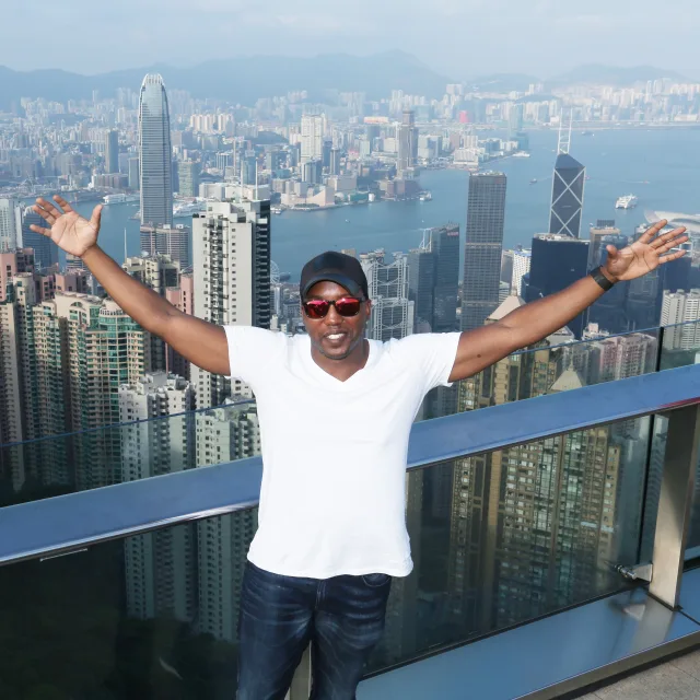 Travel Advisor Rollo Reese with a white t-shirt, jeans and a black hat at Victoria's Peak in Hong Kong.