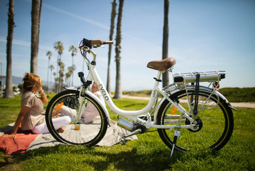 A bike and a red-haired woman in a park in Santa Barbara. 