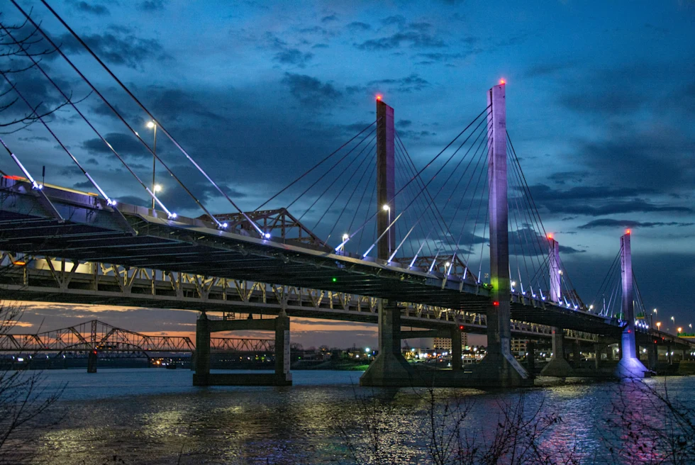 large bridge next to body of water at dusk