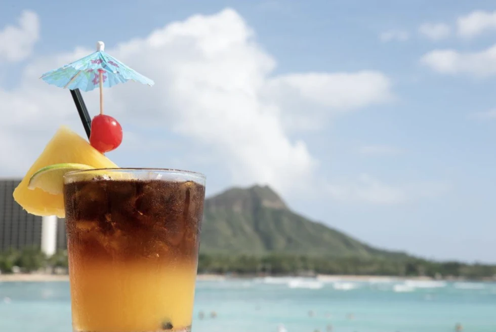 colorful drink with a pineapple with mountains in the background