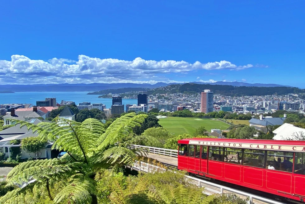 red cable car ascends 