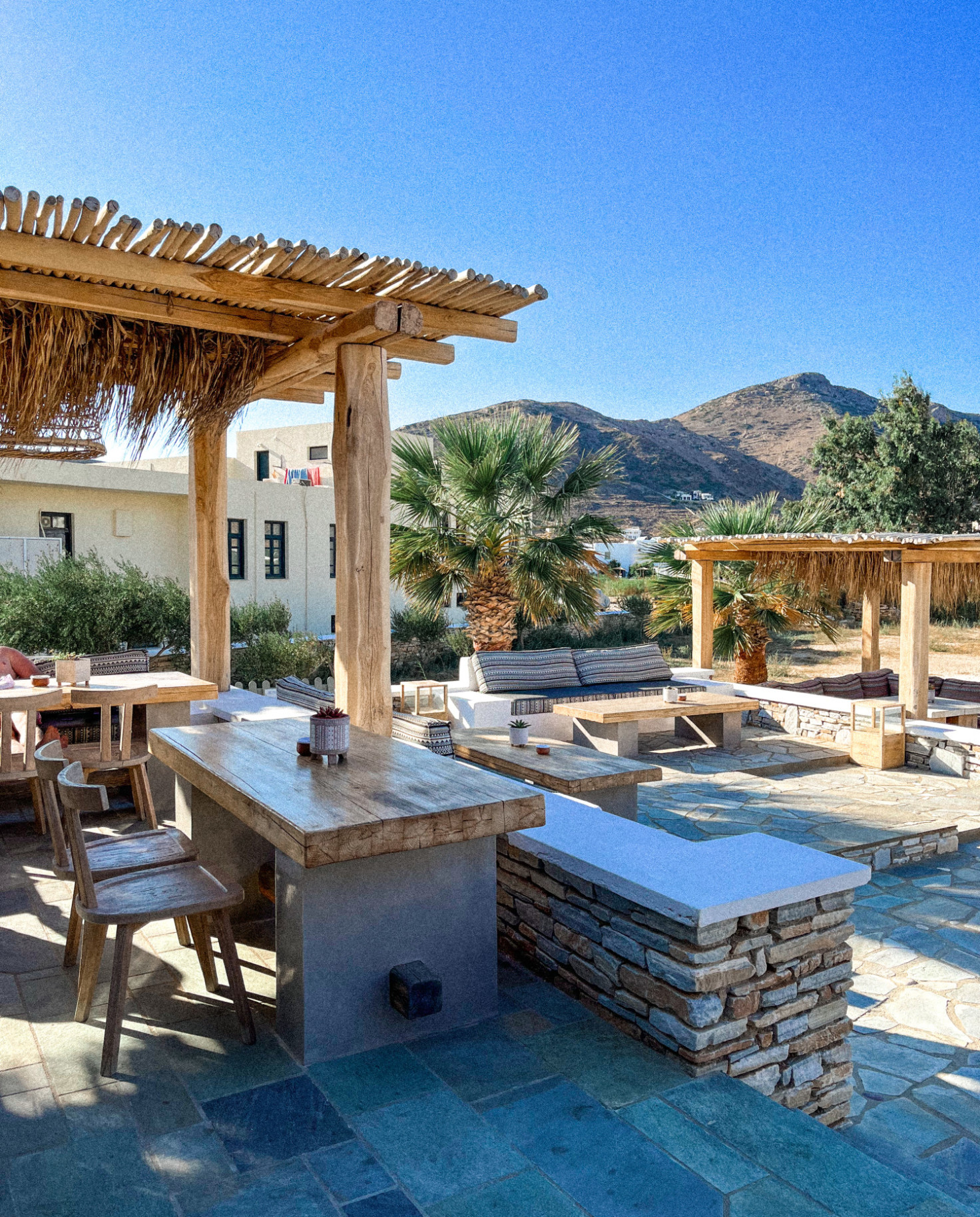 Outdoor seating area in front of Ios island at Yialos Hotel in Greece.