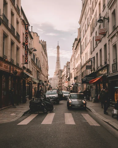 View of the Eiffel Tower at the end of a street by the best hotels in Paris for families.