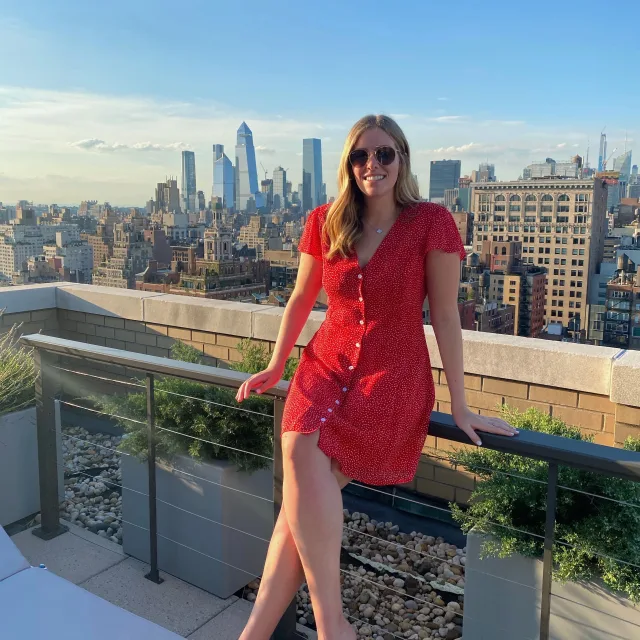 Woman in red with a spectacular city view on the backdrop