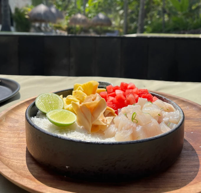 black bowl with fish and lime during daytime