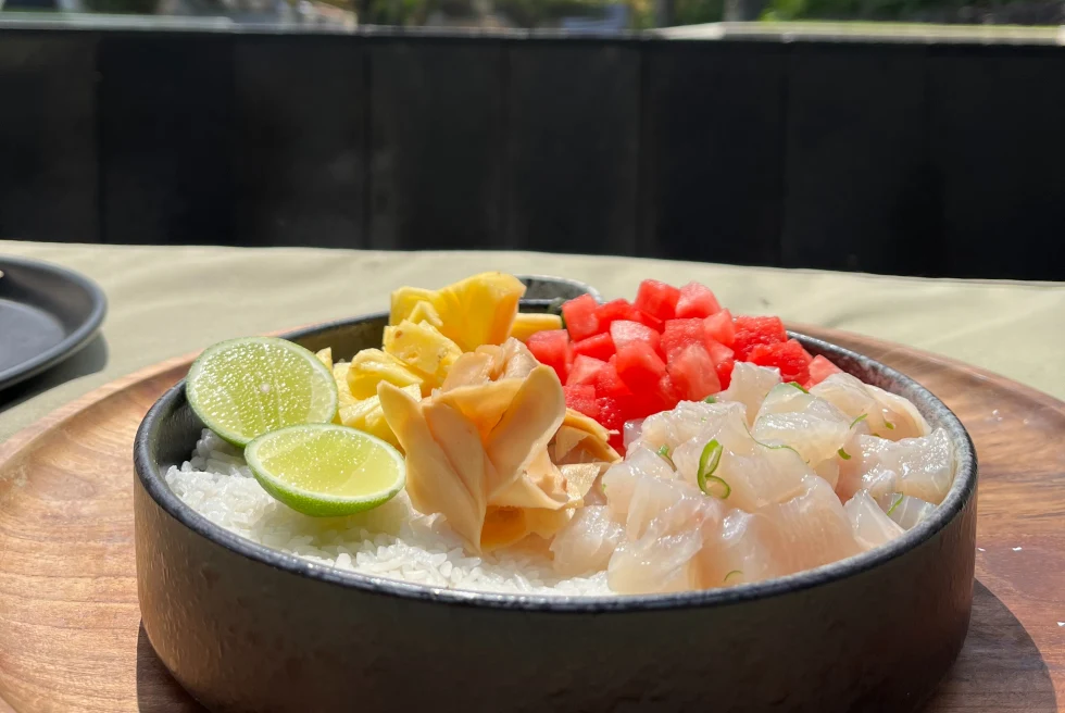 black bowl with fish and lime during daytime