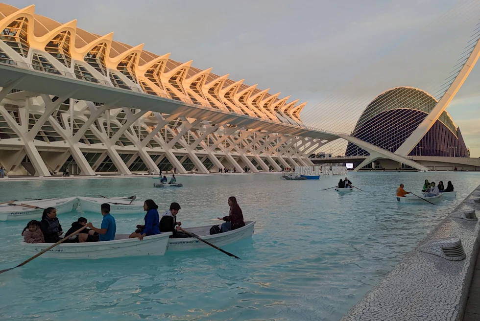 a light blue water made made pool with small paddle boats