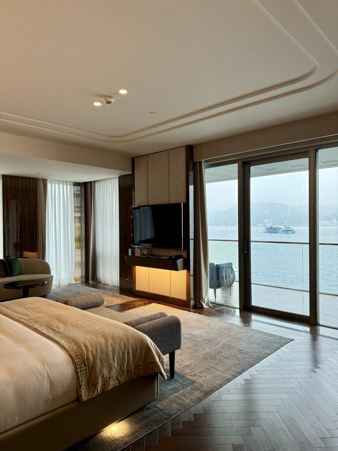 Inside one of the rooms, with a double bed, television, and a view of the Bosphorus straight.