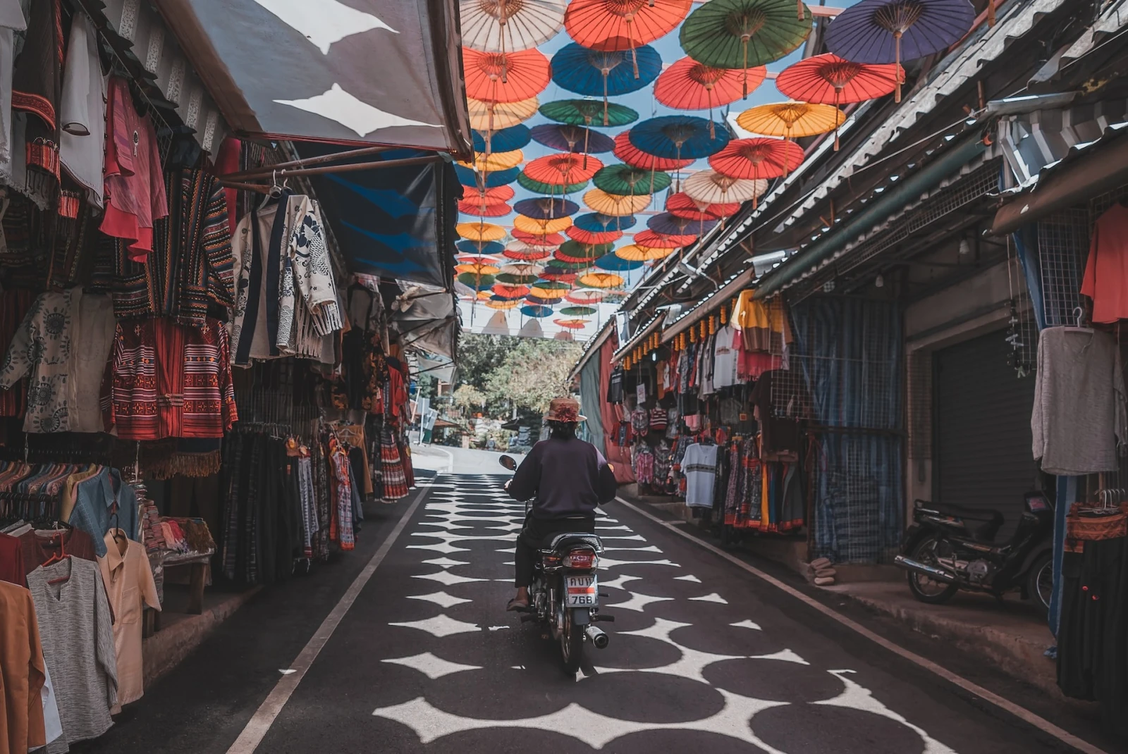 A covered market with colorful stalls in Thailand.
