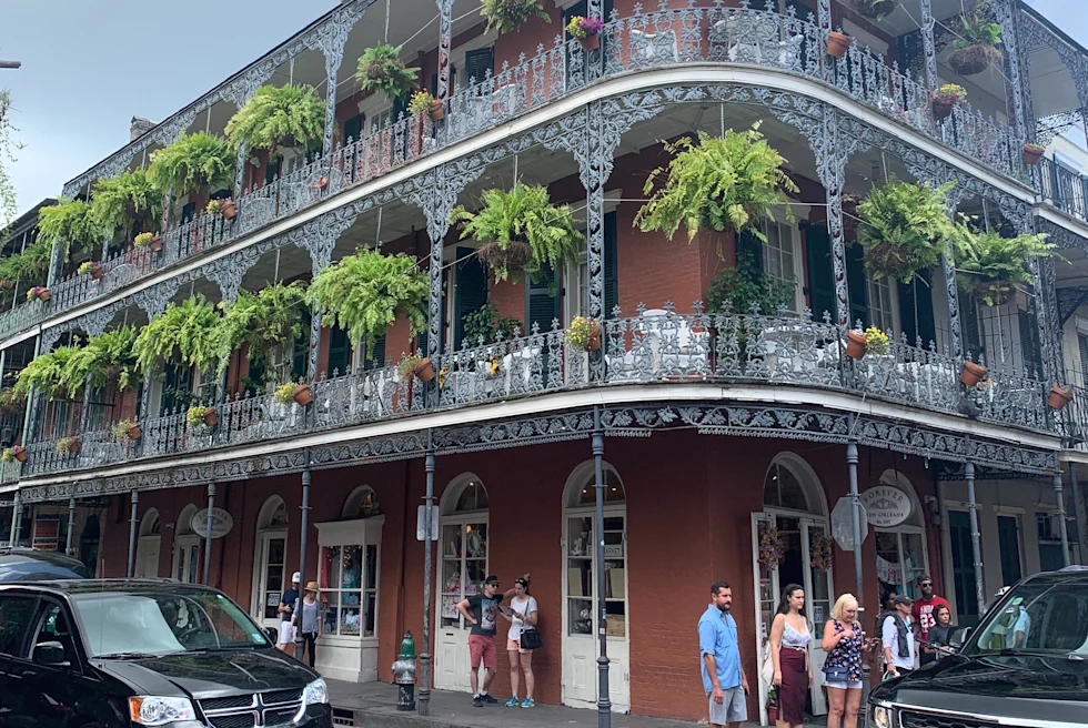 A beautiful concrete building with a lot of greenery in the balcony