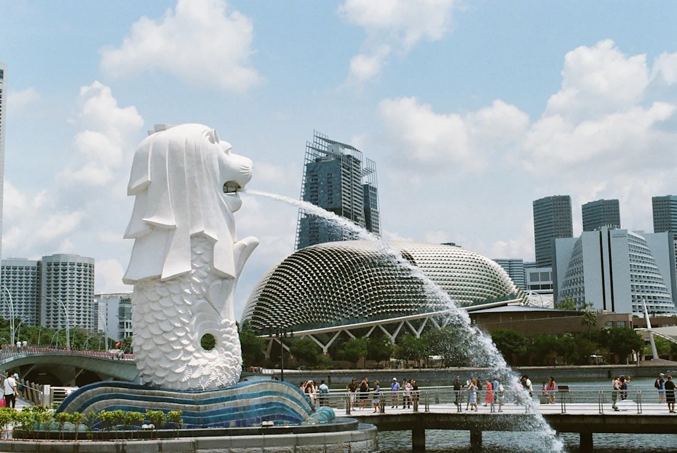 red flower-like architectural structures flanked by greenery