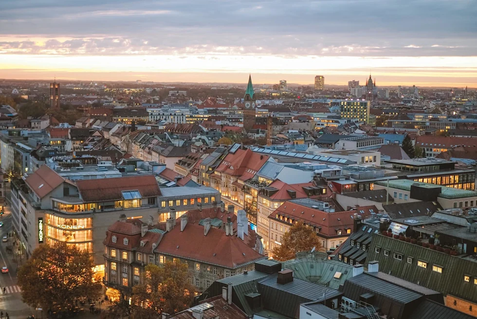 City view of Munich's historic buildings with their lights on at night.