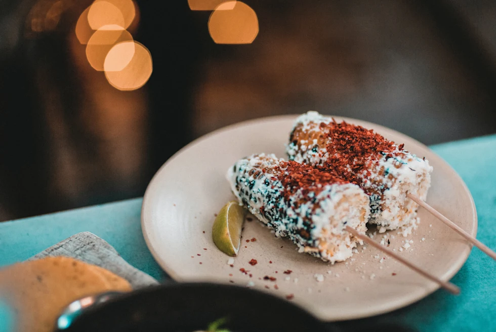 corn on a white plate on a blue table