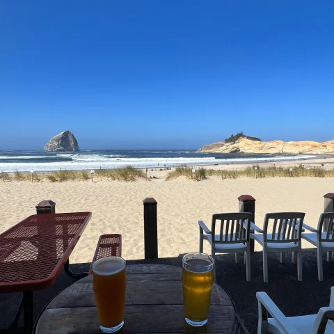 Beer at outdoor sitting of a restaurant with beach view. 