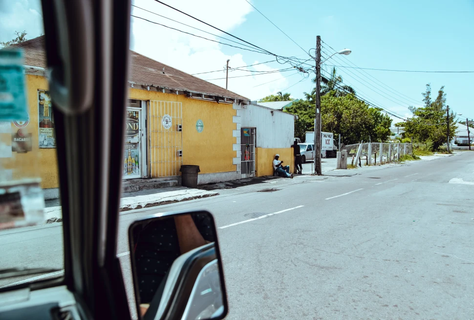 A rearview mirror of a yellow house in the Bahamas.