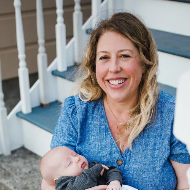 Travel Advisor Stephanie Smeekens in a blue shirt with a baby.