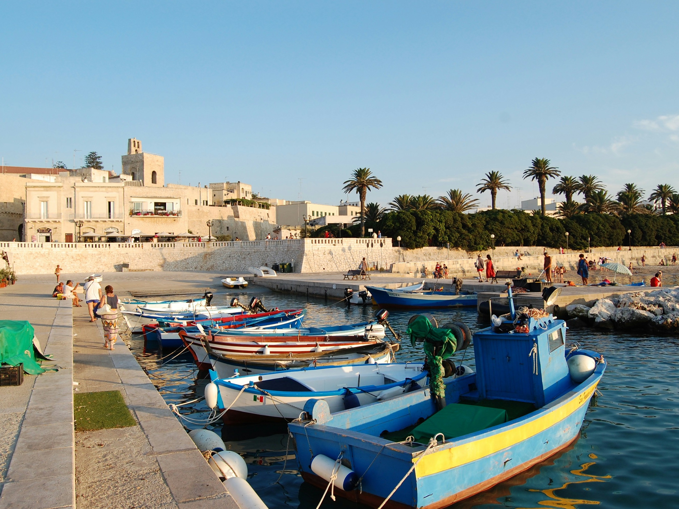 A picture of blue and white boats in a body of water during the daytime.