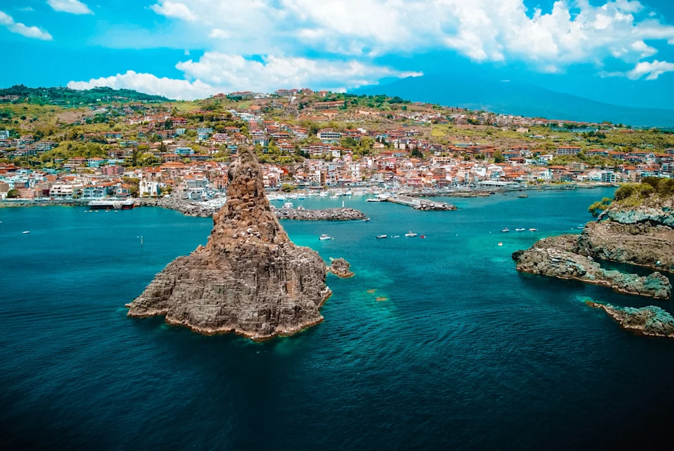 island with houses next to body of water during daytime