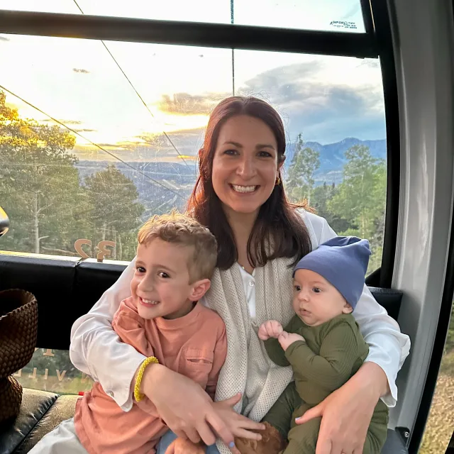 jackie with two kids in a gondola at sunset