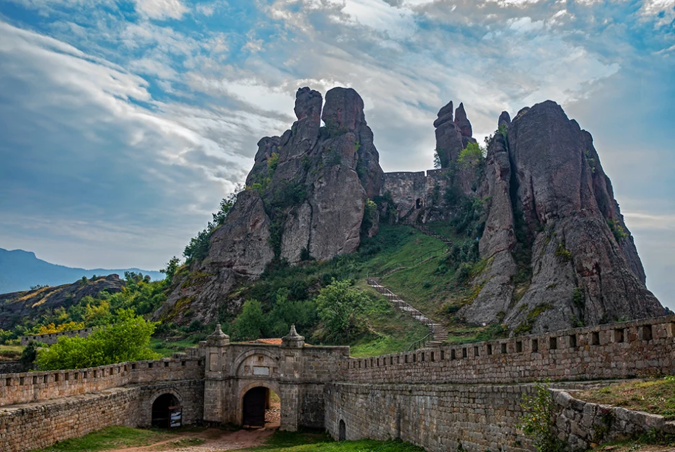 Sofia Bulgaria ancient ruins brown stone gates green grass and tall stone mountains 