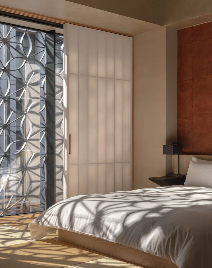 a sleek minimalist bedroom with a white bed and floor-to-ceiling wnindows